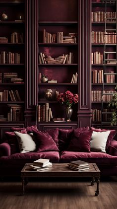 a living room filled with lots of purple furniture and bookshelves full of books