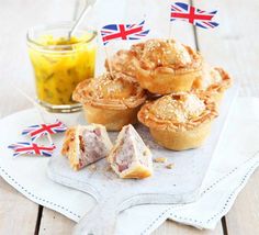 some food is sitting on a white plate and next to a cup of tea with a flag in the background