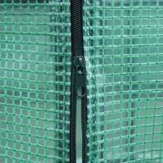 a close up view of a green mesh door with the handle on it's side