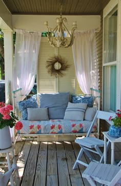 the porch is decorated with blue and white furniture