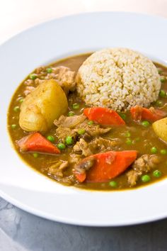 a white bowl filled with meat and vegetables