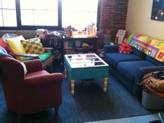 a living room filled with furniture and colorful pillows