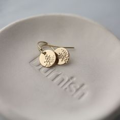 "Dainty, petite gold filled hand stamped botanical disc earrings, paired with French-style earwires. Hand stamped with a minimalist wildflower design, these petite dangle earrings are a customer favorite because they are lightweight, but not flimsy. All in 14K gold filled metal for long lasting quality. * Mini discs are 3/8 inch. * Overall earring length is about 0.75 inches. * All components are 14K gold filled. * French-style standard ear wires with clear stoppers.  * Handcrafted with love in Dainty Yellow Gold Earrings With Birth Flower, Delicate Gold Birth Flower Earrings, Dainty Yellow Gold Birth Flower Earrings, Gold Nature-inspired Earrings With Flower Charm, Nature-inspired Gold Earrings With Flower Charm, Nature-inspired Gold Flower Earrings With Charm, Minimalist Rose Gold Flower Earrings, Delicate Yellow Gold Birth Flower Earrings, Minimalist Gold Dangle Flower Earrings