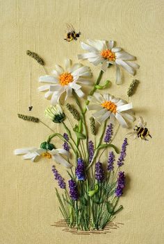 a bunch of flowers sitting on top of a table next to a beehive