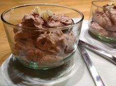 two bowls filled with food sitting on top of a table