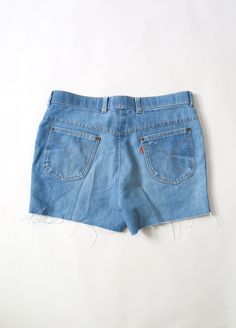 "Vintage 1970s 80s orange tab Levi's jean shorts Light wash blue jeans Levis action places with slight stretch Raw cut hem Great vintage condition - spot on back (see photos) Measurements: Waist: 17\" Total length: 14\" Rise: 11\" Inseam: 3 1/2\" +All Measurements are taking while garment is lying flat+ + Jewelry, belts, and any other accessories are NOT included unless specifically stated in description+" Retro High Waist Jean Shorts With Belt Loops, Retro Jean Shorts With Belt Loops, Vintage Light Wash Mid-rise Shorts, Retro Light Wash Short Bottoms, Retro Blue Cutoff Shorts, Vintage Cutoff Bottoms With Belt Loops, Vintage Light Wash Short Bottoms, Retro Light Wash Bottoms, Vintage Light Wash Cutoff Bottoms