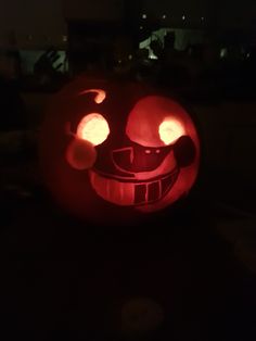 a carved pumpkin with glowing eyes and nose