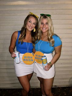 two women dressed in costumes posing for the camera with beer cans around their waists