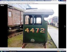 an old green train car sitting on the tracks