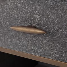 a close up view of a drawer with a metal handle on it's side