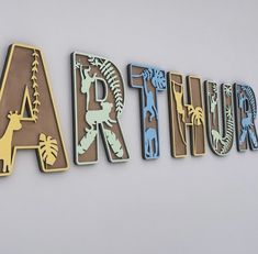 the letters are made out of wood and decorated with different types of animal silhouettes