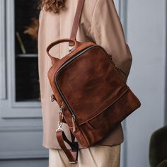 Women backpack purse, Leather back pack purse, Leather backpack women, Genuine leather backpack, Custom backpack, Work backpack women  Dimensions: Height: 33 Cm (13") Wide Top of The Bag: 23 Cm (9") Wide Bottom of The Bag: 27 Cm (10.6") Deep : 11 Cm (4.3") Cross Body strap & Back Pack straps are adjustable Introducing our versatile Backpack Purse for women, a perfect blend of style and functionality. Crafted with meticulous care, this Handmade Backpack is designed to cater to the dynamic lifesty Large Capacity Standard Backpack, Brown Backpack With Zipper For Trip, Brown Backpack With Zipper Closure For Trips, Brown Backpack For Trip, Rectangular Leather Backpack For Trips, Brown Leather Backpack For On-the-go, Brown Leather Backpack With Zipper For Trip, Leather Backpack With Zipper Closure For Everyday, Work Backpack Women