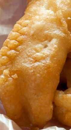 some fried food is sitting on wax paper