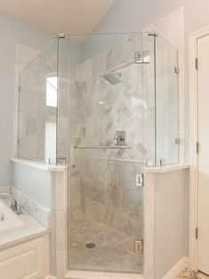 a bathroom with a walk in shower next to a sink