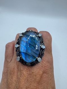 This ring is 20 grams total, consisting of 925 sterling silver, sandwiched in 18k gold around a brilliant 67.2 carat labradorite and set with 2.05 carats of diamonds and fiery rainbow moonstone  We are struggling to take photographs which do justice to the silverwork of this phenomenal one-of-a-kind ring.  This ring is part of the Nemesis Revival Collection. This is a substantial statement ring  We have in a size 9 this can be sized to your specification, please message us to discuss sizing your Mermaid Ring, 18k Gold Ring, 2 Carat, Rainbow Moonstone, Silver Band, Statement Ring, Rings Statement, 925 Sterling Silver Ring, Lovely Gift