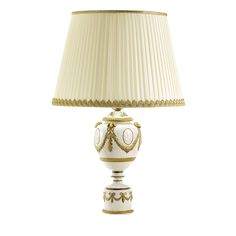 a lamp that is sitting on top of a white table with a gold trim around the base