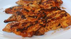 grilled chicken pieces on a white plate