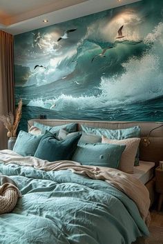 a bedroom with a large painting on the wall above the bed and ocean waves painted on the walls