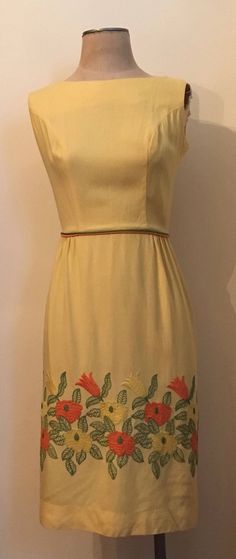 "Bright and beautiful yellow embroidered sleeveless dress from the 1960's is a figure hugging spring essential! Dress is made from a lightweight cotton/rayon and zips up the back with hook and eyes at the waistline and the back of the neck. Dress is in excellent vintage condition. Shoulders 14\" Chest 38\" Waist 25\" Hips 38\" Length from top of shoulder to hem 40\" Armhole 8\" Vintage garments have been previously worn and lovingly cared for, they may however have a blemish or two. Here at Made Yellow Vintage A-line Dress For Spring, Yellow A-line Vintage Dress For Spring, Spring Yellow A-line Vintage Dress, Vintage Sleeveless Embroidered Dress, Vintage Embroidered Sleeveless Dress, 1950s Style Sleeveless Spring Vintage Dress, Spring Yellow Vintage Dress For Daywear, Yellow Vintage Dress For Spring Daywear, Mid-century Knee-length Vintage Dress For Spring