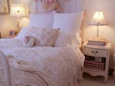 there is a bed with white comforter and pillows