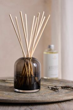 an image of reed sticks in a glass container