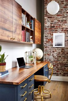 a wooden desk topped with a laptop computer sitting on top of a hard wood floor