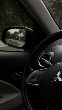 the inside view of a car's dashboard with trees in the background