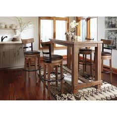 a kitchen table with four stools in front of it