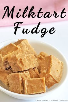 a white bowl filled with fudge next to a pink napkin on top of a table