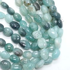 the beads are blue and green with white speckles on them, along with other stones