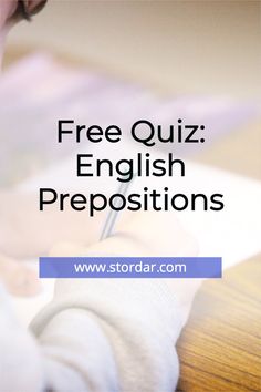 a person writing on a piece of paper with the words free quiz english prepositions