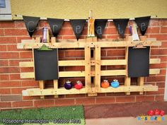 a wooden pallet with chalkboards and magnets attached to the side of it