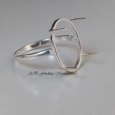 a silver ring sitting on top of a white table