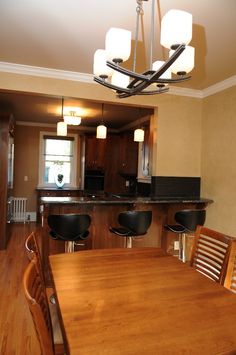 a dining room table with four chairs around it