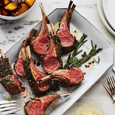 steaks and potatoes on a plate with a fork