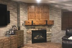 a living room with a fireplace and tv mounted on the wall above it's mantle