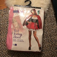 there is a bag with a red riding hood on it, and the package has an image of a woman in a costume