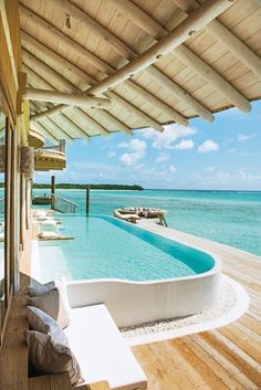 an outdoor swimming pool next to the ocean