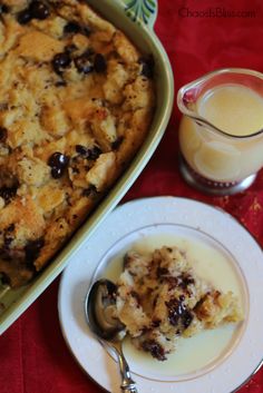 a casserole dish on a plate next to a glass of milk