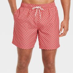 Make a splash in the backyard pool or at the beach wearing these Geometric Print Swim Shorts from Goodfellow & Co™. These lightweight swim trunks designed with a built-in mesh brief offer you comfy, confident wear in or out of the water. Featuring a coral orange geometric pattern for an eye-catching, on-trend look, these regular fit swim trunks will pair well with a variety of rash guards, tees or tanks for versatile swimwear options. The full elastic waistband and adjustable drawstring help you Men’s Swimwear Fashion, Beach Wearing, Ralph Lauren Menswear, Honeymoon Outfits, Family Women, Printed Swim, Coral Orange, Swimsuit Shops, Hem Style