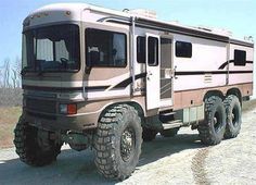 an off road vehicle parked on the side of a dirt road