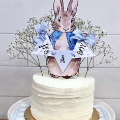 a cake decorated with an image of a rabbit and baby's breath on top