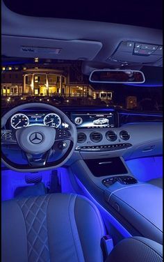 the interior of a car with blue lights