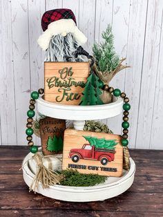 a three tiered christmas tree decorated with ornaments and wood blocks that read oh christmas tree