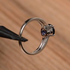 It is a lab sapphire ring. The main stone is 7mm*7mm round cut, weight about 1.66 carats. The basic metal is sterling silver and plated with rhodium. To change the metal to a solid gold (white/rose) or platinum is also available, please ask for a quotation if you want. You can also go to my shop Home for more elegant rings: https://www.etsy.com/shop/godjewelry?ref=hdr_shop_menu More sapphire rings: https://www.etsy.com/shop/godjewelry?ref=seller-platform-mcnav&section_id=20715031 Customizati Silver Sapphire Ring With Birthstone, Lab-created Sapphire Round Band Promise Ring, Lab-created Sapphire Promise Ring With Round Band, Silver Solitaire Sapphire Promise Ring, Silver Round Sapphire Promise Ring, Silver Sapphire Ring With Prong Setting For Promise, Sapphire Promise Ring With Prong Setting And Round Stone, Sapphire Ring With Prong Setting For Promise, Lab-created Sapphire Promise Ring