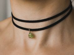 Raw peridot choker made of a black vegan leather strap. The gemstone is wrapped with a high quality wire as a pendant. The chain is adjustable in length to fit a neck circumference of approximately 28cm to 35cm. The raw black tourmaline, is one of the most sought after stones for protection and purification.  It helps to prevent the intrusion of negative or unwanted energies and to ground oneself.  Birthstone October. ✦ BROWN CHOKER COLOR follow this link ✦ https://www.etsy.com/de/listing/1557895079/roher-peridot-choker-peridot-kette?click_key=dafa073e46b3612dd7d42a85095ead822a3be1a0%3A1557895079&click_sum=a45027e5&ref=shop_home_active_8&frs=1 ✦ HIGH QUALITY MATERIAL | COLOR ✦ Raw peridot Stone size: 8-10mm Wire: gold filled / sterling silver (waterproof!) Discreet clasp: sterling silver B Green Adjustable Birthstone Jewelry, Adjustable Green Birthstone Jewelry, Adjustable May Birthstone Pendant Jewelry, Adjustable Pendant Jewelry With May Birthstone, Adjustable Pendant Jewelry For May Birthstone, May Birthstone Jewelry Pendant, Adjustable Gemstone Choker Jewelry, Dainty Adjustable Green Crystal Necklaces, Dainty Adjustable Green Crystal Necklace