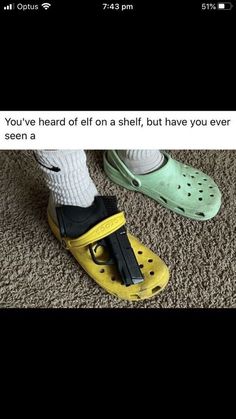 someone wearing crocs with their feet in yellow and green shoes on the floor