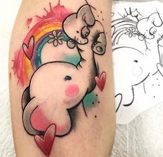 an elephant tattoo on the leg with hearts and rainbows around it's neck