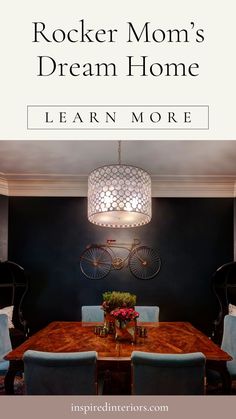 a dining room table with blue chairs and a chandelier hanging from the ceiling