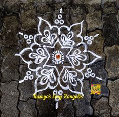 a white flower drawn on the ground with words written below it and an orange dot in the middle